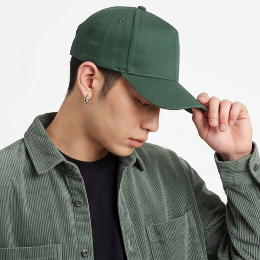 Person wearing a green trucker cap and matching jacket against a neutral background