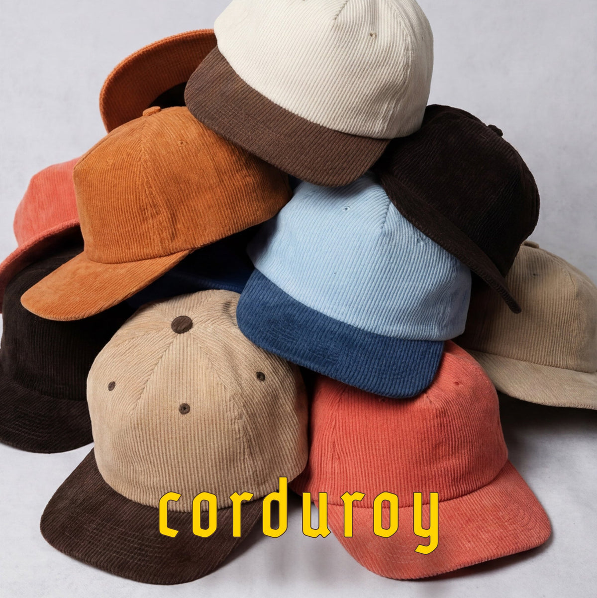 stack of corduroy hats in multiple colors
