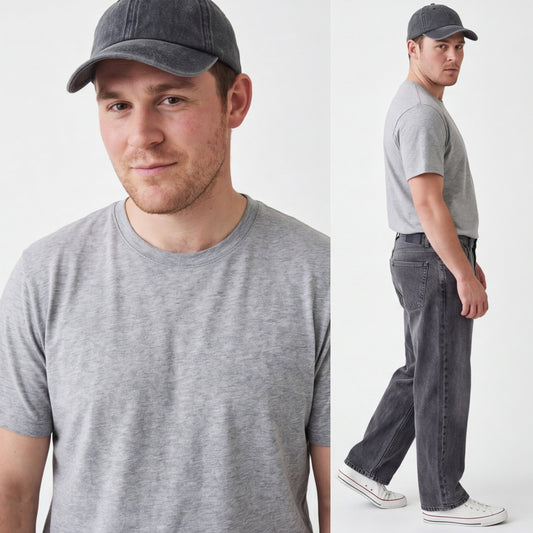 Man wearing a gray t-shirt and cap, standing against a white background
