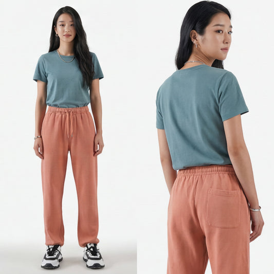 Woman wearing a blue t-shirt and pink jogger pants, shown from front and back on a white background.