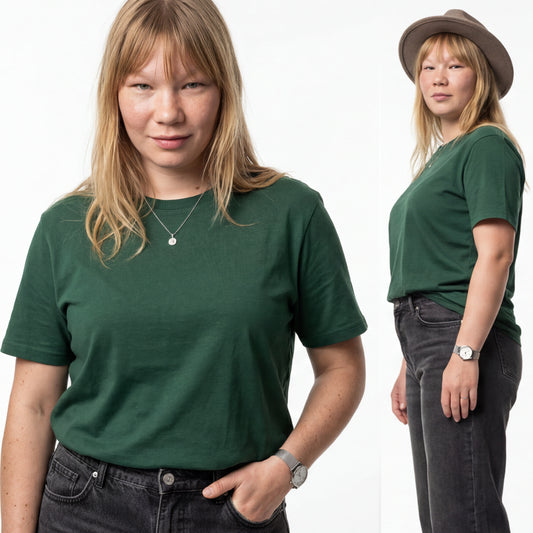 Woman wearing a green t-shirt and dark jeans on a white background