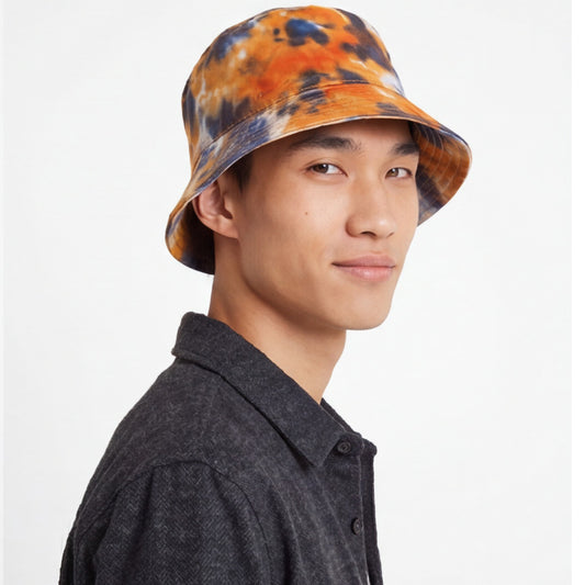 Person wearing a tie-dye bucket hat on a white background