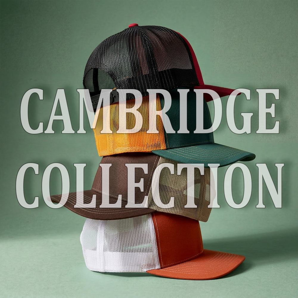 Stack of colorful caps with 'Cambridge Collection' text on a green background