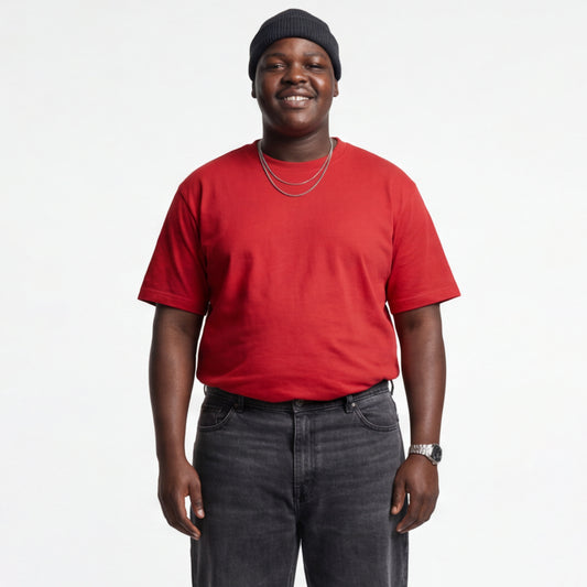 Person wearing a short sleeve red t-shirt and black beanie on a white background