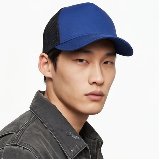 Man wearing a blue trucker cap and dark jacket on a white background